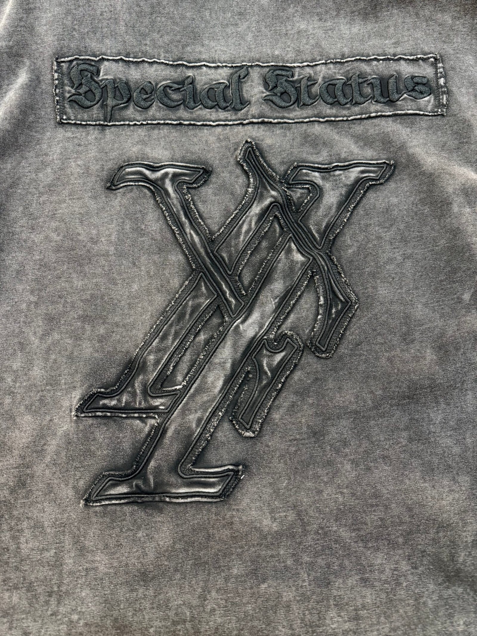 Custom t-shirt with distressed wash, applique patch, and embroidery by DeCheng Garment