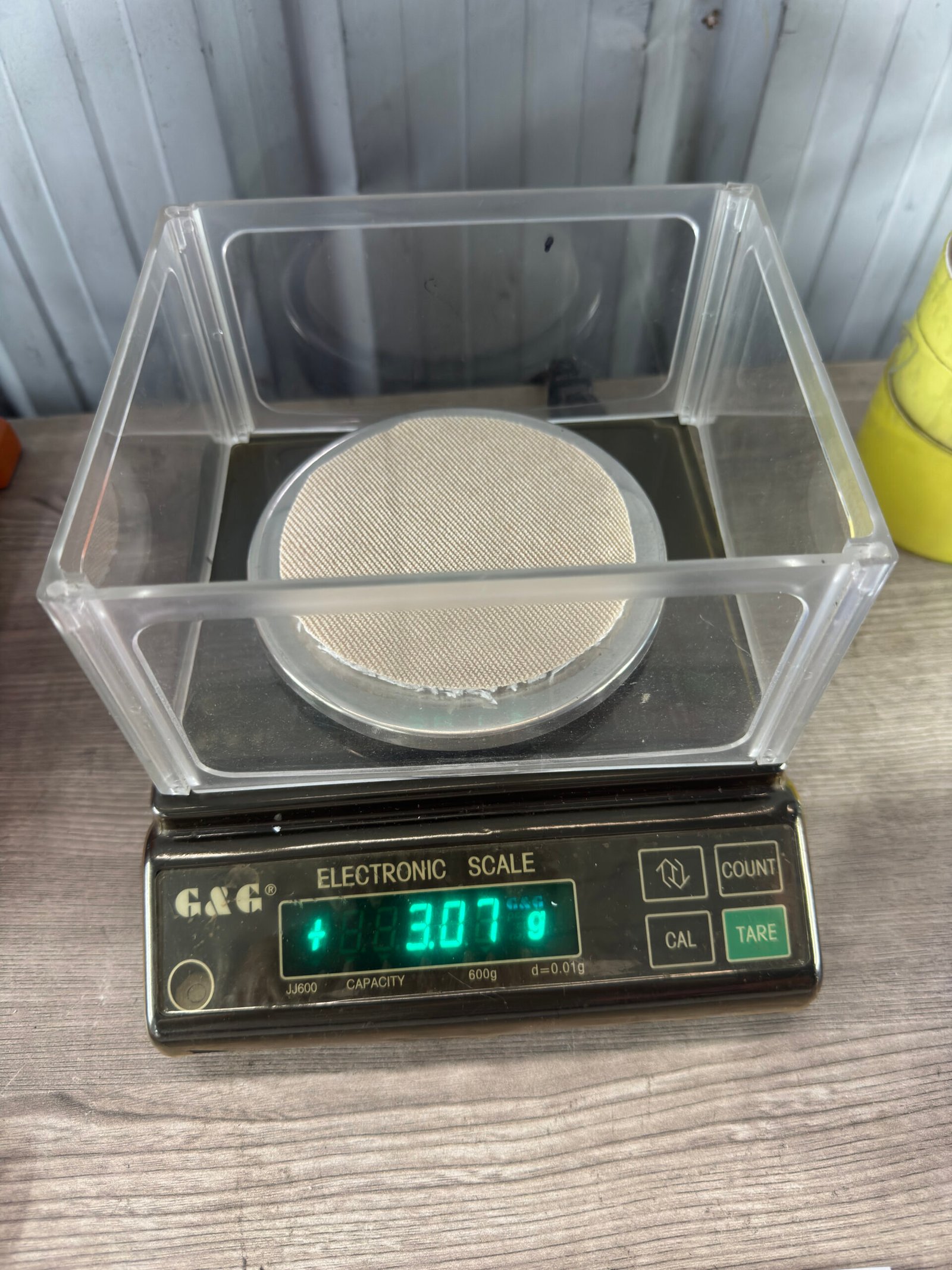 Fabric weight verification using digital scale at DeCheng Garment for GSM quality control