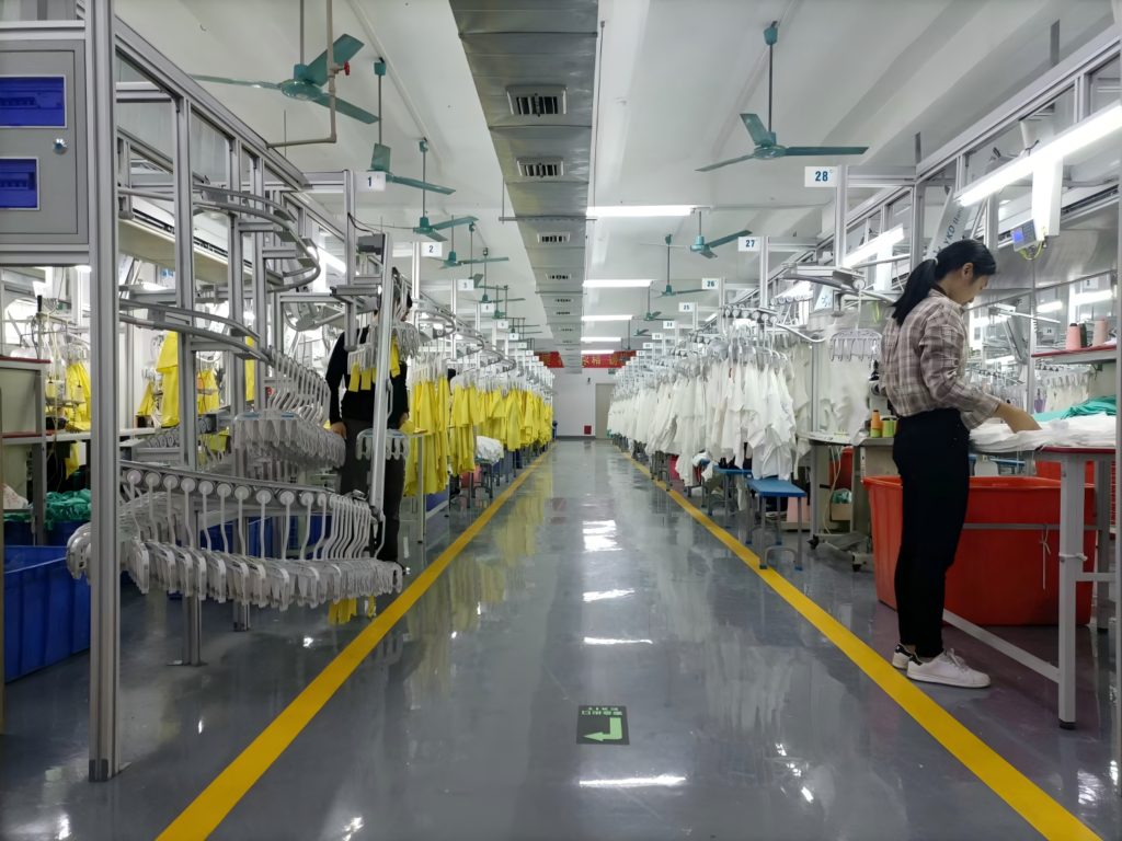 Real Chinese clothing factory sewing department with active workers proving in-house production capacity